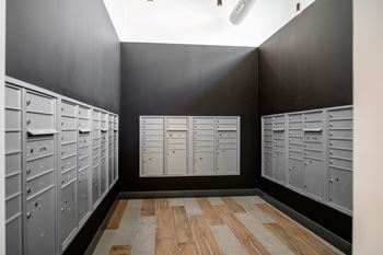 A row of lockers in a room with wooden flooring.